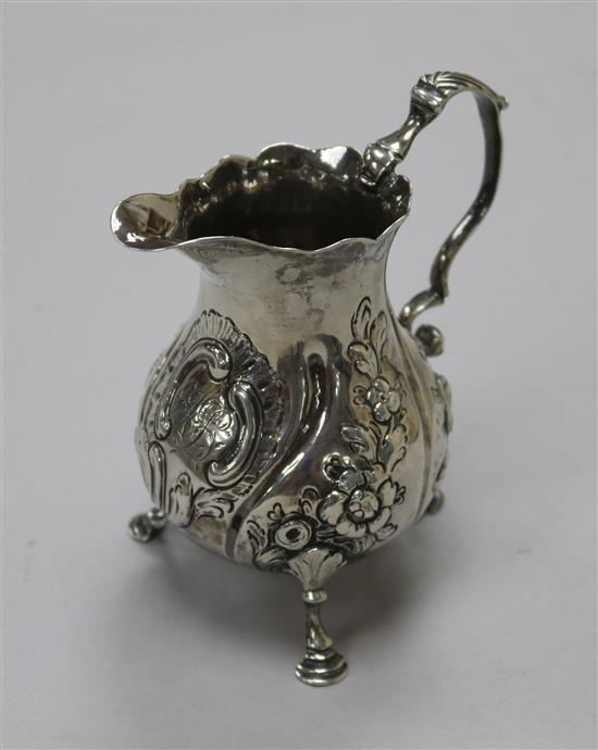 A George III silver cream jug, with later embossed decoration, London, 1762,